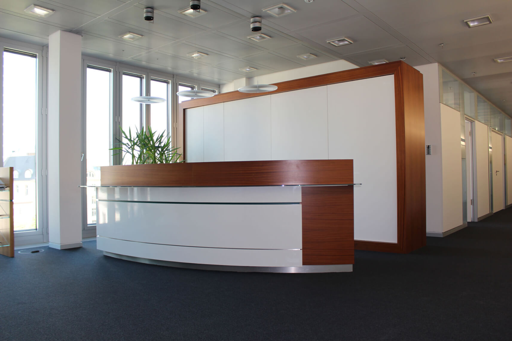 Office partition walls of a wooden desk in white, coated with self-adhesive film - after